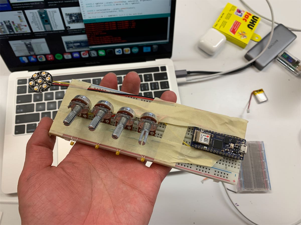 on a breadboard, there are four potentiometer controling the color of the neopixel